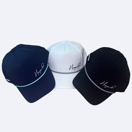 Three baseball caps in navy, white, and black with a brand logo on a light gray background